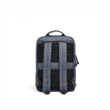 Mueslii small backpack,  made of  water resistant canvas nylon,  with a laptop compartment, color slate grey, back view.